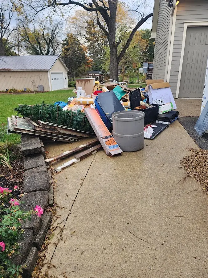 Dumpster being loaded with debris for 12 Yard Dumpster Rental in Red Bluff
